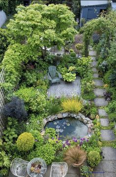 an aerial view of a garden with lots of plants and chairs in the foreground