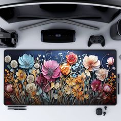 an overhead view of a video game console with flowers painted on it