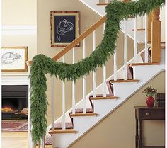 the stairs are decorated with garland for christmas