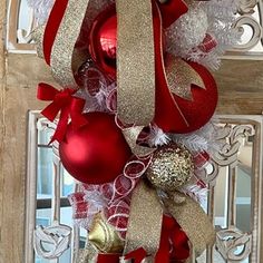 a red and gold christmas wreath with ornaments