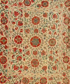 an antique rug with red and green flowers