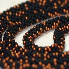 two strands of black and copper seed beads