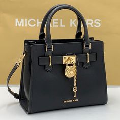 Michael Kors Hamilton Small Satchel Shoulder Crossbody Bag Pebbled Leather Michael Kors Logo At Front Zip Top Closure Gold Toned Hardware Black Color Mk Key & Lock On Front Custom Mk Fabric Lining 1 Slip-In Pockets 1 Zipper Pocket 10" (L) X 8"(H) X 4"(D) Strap: 4", 18"- 24" Very Clean, Smoke-Free And Pet-Free Environment Black Rectangular Satchel With Lock, Black Bags With Lock For Daily Use, Tote Bag With Lock, Elegant Evening Bags With Lock, Michael Kors Black Bag With Top Carry Handle, Black Michael Kors Bag With Top Carry Handle, Black Top Handle Satchel With Lock, Black Shoulder Bag With Lock, Black Shoulder Bag With Lock For Everyday