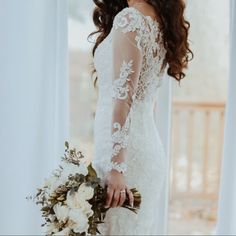 a woman in a wedding dress holding a bouquet