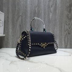 SHOP MORE LUXURY PRODUCTS HERE Description Valentino Rivet Rockstud Bag Dark Blue, For Women, Women’s Bags 11.8in/30cm Size:ÃƒÂ¯Ã‚Â¿Ã‚Â½ÃƒÂ¯Ã‚Â¿Ã‚Â½ÃƒÂ¯Ã‚Â¿Ã‚Â½ÃƒÂ¯Ã‚Â¿Ã‚Â½ 30 x 13 x 6 cm /11.8 x 5.1 x 2.4 inches (Width x Height x Length) Valentino new ROCKSTUD grained tote, original grained with plating rivets, hand inlaid, comfortable and three-dimensional package, exaggerated personality, never follow the crowd, strong punk style, with long shoulder strap, portable Includes dust bag.Thi Leather Party Bag With Studs, Studded Leather Party Bag, Evening Shoulder Bag With Studs, Studded Evening Shoulder Bag, Luxury Studded Shoulder Bag, Everyday Studded Bags, Studded Rectangular Bag For Everyday Use, Elegant Leather Bag With Studs, Studded Evening Bag