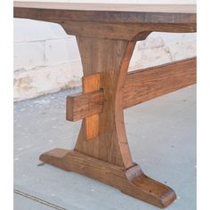 a wooden bench sitting on top of a cement floor