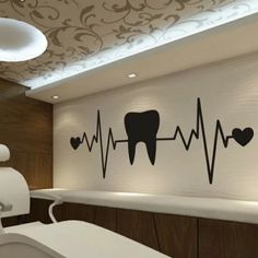 a dentist's office with a wall decal that has a heart beat on it