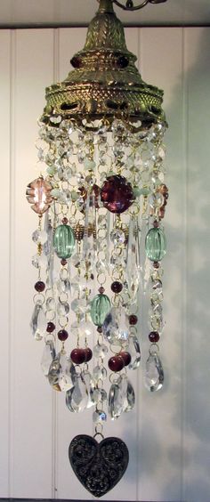 a chandelier hanging from the side of a wall next to a heart shaped object