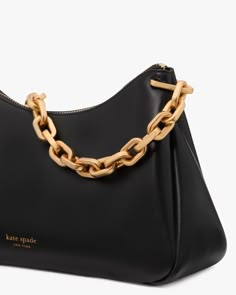 Sport a handbag that stands out with the black Grace Chain Shoulder Bag from kate spade new york. The Grace style is timeless and classic, finished with sleek fine grain black leather. This handbag's gold chain strap is what makes it unlike all the other black handbags out there, making it go from just versatile to versatile and unique. Wear it over the shoulder with any outfit for any occasion. Take on your days with grace wearing the Grace Chain Shoulder Bag from kate spade new york! Modern Formal Shoulder Bag With Chain Detail, Modern Formal Shoulder Bag With Chain, Modern Evening Shoulder Bag With Chain Link, Modern Chain Link Shoulder Bag For Evening, Modern Bags With Gold Chain, Kate Spade Rectangular Shoulder Bag With Chain Strap, Chic Everyday Luxury Shoulder Bag With Chain, Formal Chain Link Shoulder Bag With Chain Details, Luxury Kate Spade Shoulder Bag With Chain Strap