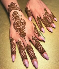 two hands with henna tattoos on them