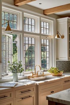 a kitchen filled with lots of windows next to a sink