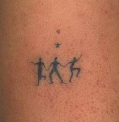 a tattoo on the back of a person's leg with two people holding hands