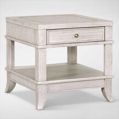 a white wooden end table with drawers on one side and an open drawer on the other