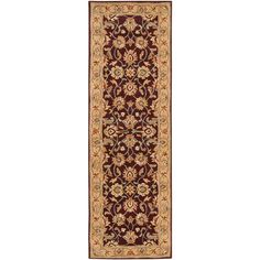 a brown and gold rug with an ornate design on the bottom, in front of a white background