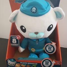 a blue and white stuffed animal in a box