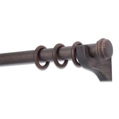 a wooden curtain rod with two rings on it