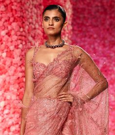 Illuminate your look with this candy pink shimmer tulle sari set. The sari features delicate shimmer tulle embroidered with intricate patterns, offering a vibrant and graceful drape. It is beautifully accentuated by a hand-molded wire corsage, adding a unique, artistic touch to the ensemble. This combination of shimmering fabric and sculptural detailing creates a sophisticated and eye-catching appearance. Wire Corsage, Candy Pink, Pink Candy, Intricate Patterns, Pink Fabric, Petticoat, Indian Outfits, Evening Wear, Occasion Wear