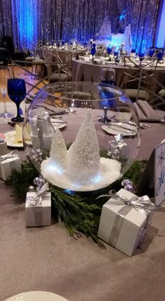 a table set up with presents and wine glasses