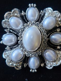 This PIN / BROOCH is a stunning silvertone CROSS set with faux BAROQUE PEARLS & clear rhinestones. NOW ON SALE (as it has a slight defect in center pearl...see pix). Still a beautiful piece, it could be be worn on a jacket, with a scarf, or at the neck of an equestrian hunt shirt or stock tie! (check out possible coordinating stock ties & points in our Etsy shop!) Add a bale and wear it as a pendant! Dressage ladies....use this STUNNER on your STOCK TIE!! Measures about 2" in diameter. Stock Tie, Be Be, Baroque Pearls, Dressage, Clear Rhinestones, Pin Brooch, Vintage Looks, Faux Pearl, Brooch Pin