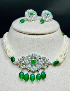 Add a touch of Indian elegance to your outfit with this stunning jewelry set! This exquisite set features: - A beautiful Green-quartz stone necklace with intricate craftsmanship - A pair of matching earrings with moti beads and quartz stones - A delicate moti bead chain with a quartz stone pendant The combination of Green-quartz stones and moti beads creates a striking visual effect that's sure to turn heads. Perfect for: - Traditional Indian occasions like weddings and festivals - Everyday wear White Gemstone Beads Jewelry For Festive Occasion, Festive White Gemstone Beads Jewelry, Festive White Jewelry With Gemstone Beads, Traditional White Jewelry With Gemstone Beads, Traditional White Gemstone Beads Jewelry, Elegant Jewelry Sets With Natural Stones, Elegant Wedding Earrings With Gemstone Beads, White Gemstone Beads Jewelry For Parties, White Gemstone Beads Jewelry For Wedding