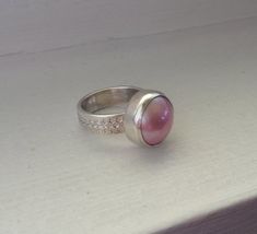 Elegant Romantic Blush Pink Mabe South Sea Pearl in Sterling Silver with Sterling Silver Decorative Pink Ring With Bezel Setting, Pink Bezel Set Ring, Pink Bezel Set Ring Jewelry, Pink Sterling Silver Moonstone Promise Ring, Elegant Pink Moonstone Sterling Silver Ring, Pink Ring With Polished Finish, Pink Moonstone Sterling Silver Ring For Anniversary, Pink Round Band Jewelry With Bezel Setting, Pink Jewelry With Bezel Setting And Round Band