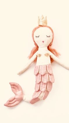 a pink mermaid doll with a crown on her head