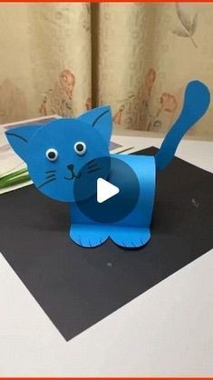 a blue paper cat on top of a table