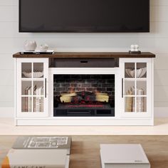 an entertainment center with a fireplace in the middle and books on the table beside it