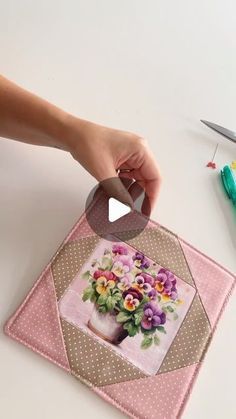 someone is making a flower arrangement out of fabric