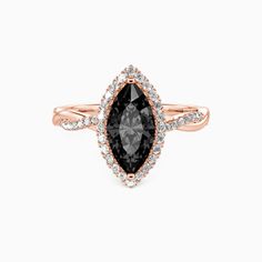 an engagement ring with a pear shaped black diamond surrounded by small white and pink diamonds