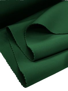 the green fabric is folded on top of each other