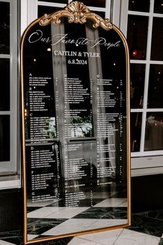 the seating chart for an event is displayed in front of a large glass sign that reads,