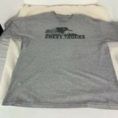 Vintage Gray Chevy Trucks X Large No Tags T Shirt. Please see photos for condition and size. Per photos there is a Fingerprint size dark gray discoloration in the front of this shirt. No rips. Gray Crew Neck Graphic Tee Shirt, Gray Crew Neck Top With Graphic Print, Gray Graphic Print Crew Neck Top, Gray Crew Neck Top With Logo Print, Gray Crew Neck Shirt With Text Print, Gray Crew Neck Shirt With Logo Print, Over Sized, Chevy Trucks, T Shirt Women