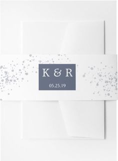 a white envelope with silver confetti on it and the initials k & r