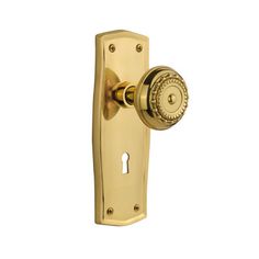 a golden door handle with a round knob on it's left side and a white background