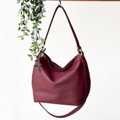 **THE PICTURES SHOW THE LARGE SIZE ** A slouchy shoulder bag for women in soft and supple red leather, designed with many pockets and accompanied with a cross body strap. The Helen soft & slouchy collection is an everyday hobo bag in a simple and stylish design. FEATURES: -Removable and adjustable cross body strap - Shoulder strap with a 11.7 " drop - Secure top zipper closure with a zipper pull -2 in one design : hobo purse and a woman's laptop purse -laptop compartment for a 13'' laptop  -Larg Laptop Purse, Red Leather Bag, Hobo Purse, Leather Conditioner, Water Repellent Fabric, Laptop Pocket, Hobo Handbags, Design Simple, Small Accessories