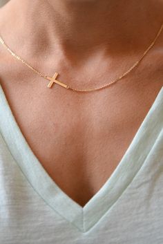 "I am obsessed with this necklace. I have been a long time fan of a classic gold cross necklace....a simple and classic daily wear. In my attempt to edge it up bit, I anchored a lovely Gold Filled Cross Pendant Sideways. The cross measures 9.5 mm by 17 mm (FYI-for reference 1 inch = 24.6 mm) and is strung on my Gold Filled Shimmer Bar Chain. So precious! Feminine and delicate, this is my go to necklace and the perfect gift. Also available with a bolder cross that measures 14.5 mm x 22.4 mm! Phot Everyday Cross Pendant Clavicle Necklace, Minimalist Cross Chain Necklace With Delicate Chain, Everyday Clavicle Chain Necklace With Cross Pendant, Minimalist Delicate Chain Cross Necklace, Minimalist Jewelry With Adjustable Chain And Cross Pendant, Gold Jewelry With Cross Pendant For Everyday, Minimalist Yellow Gold Cross Necklace With Clavicle Chain, Minimalist Cross Pendant Necklace For Everyday, Everyday Cross Necklace With Clavicle Chain