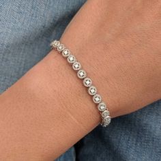 We took a classic tennis bracelet and added vintage charm with delicate milgrain detailing. The bracelet is finished with a box clasp with locking hinge for added security. This bracelet is fully customizable. If you prefer 18k gold or platinum, different dimensions, different quality diamonds or moissanites or colored gemstones, please contact us: http://etsy.me/1231fkN Details: - Solid 14k yellow or white gold - Bracelet is 7 inches in length. For different lengths, please contact us. - SI+G/H Diamond White Jubilee Tennis Bracelet For Anniversary, Classic Bezel Setting Tennis Bracelet For Formal Occasions, Timeless Round Tennis Bracelet With Diamond Accents, Classic Round Diamond Cut Tennis Bracelet, Classic Tennis Bracelet In Diamond White With Diamond Cut, Classic Jewelry With Single Cut Diamonds, Classic Round Tennis Bracelet With Diamond Cut, Elegant Diamond White Tennis Bracelet With Bezel Setting, Elegant Tennis Bracelet In Diamond White With Bezel Setting