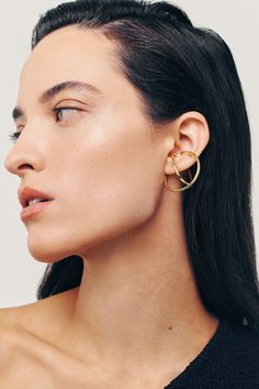 Metal Hoop Ear Cuff For Pierced Ears, Adjustable Modern Single Wrap Earring, Modern Adjustable Single Wrap Earring, Modern Brass Wrap Earrings For Pierced Ears, Modern Hoop Ear Cuff With Ear Wire, Modern Gold Round Ear Cuff, Modern Pierced Ear Cuff For Parties, Modern Round Ear Cuff, Modern Metal Pierced Ear Cuff