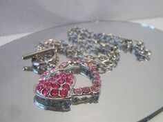 Pink double heart necklace. It measures approx. 19 inches and has a toggle clasp closure. Made with a light pink rhinestone heart silhouette and a smaller solid hot pink rhinestone heart. Silver tone. Perfect for give or wear on Valentine's Day. All sales are final and as is. Thank you for looking. You may also love this: https://www.etsy.com/listing/584789387/heart-silhouette-pendant-necklace?ref=shop_home_active_1 Valentine's Day Double Heart Rhinestone Jewelry, Heart Shaped Rhinestone Necklace For Valentine's Day, Heart-shaped Rhinestone Necklace For Valentine's Day, Valentine's Day Heart Rhinestone Necklace Gift, Valentine's Day Gift Rhinestone Necklace, Pink Heart-shaped Rhinestone Necklace, Pink Heart-shaped Necklace With Rhinestones, Pink Bling Necklace For Gift, Pink Heart-shaped Jewelry With Lobster Clasp