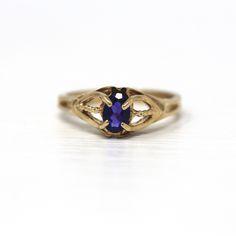 Gorgeous vintage circa 1970s retro era 10k yellow gold created sapphire ring! This stunning statement ring features an oval faceted .38 carat created purple sapphire, that is securely prong set. The shoulders have a split shank style design, and have twisted details up the center of each side. Incredible signed created sapphire ring, ready to be worn! *Sale - price reduced from $310 USD to $295 USD.  ERA - Circa 1970s - Retro METAL / MATERIAL - 10k yellow gold, oval cut created purple sapphire ( Vintage Oval Sapphire Birthstone Ring, Vintage Oval Sapphire Ring As Birthstone, Vintage Yellow Gold Gemstone Ring, Vintage Yellow Gold Hallmarked Birthstone Ring, Vintage Oval Sapphire Ring Hallmarked, Vintage Yellow Gold Round Birthstone Ring, Vintage Hallmarked Yellow Gold Birthstone Ring, Vintage 14k Gold Round Birthstone Ring, Vintage Oval Sapphire Ring With Hallmark