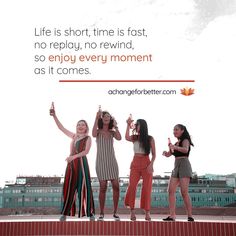 three women standing on top of a brick wall with their arms up in the air