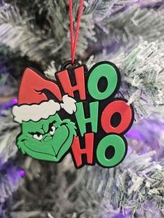 a christmas ornament hanging from a tree with the word ho hoo on it