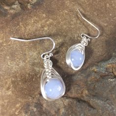 These beautiful Blue Lace Agate Earrings are truly unique. Blue lace agate stone has a soothing nurturing energy. The light blue color of the stone is beautiful in its simplicity, which is why I chose to wrap it in a simple herringbone design with silver plated wire to let the stone shine through. Each stone has been carefully selected for these pair of earrings. They are made completely by hand by me. Pleasingly simple yet extraordinary, these earrings can be worn dressed up or down. They are e Handmade Chalcedony Earrings For Gifts, Handmade Chalcedony Earrings As Gift, Teardrop Agate Earrings As Gift, Teardrop Agate Earrings For Gift, Agate Teardrop Earrings For Gift, Nickel-free Agate Earrings For Gifts, Blue Natural Stone Earrings As Gift, Wire Wrapped Agate Earrings For Gift, Wire Wrapped Agate Earrings As Gift