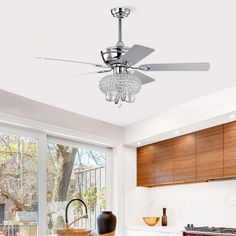 a ceiling fan in the middle of a kitchen