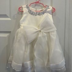 Ivory Flower Girl Dress With Silver Stones, Never Worn. Beautifully Made. White Princess Dress With Bow For Spring, White Baptism Dress With Bow For Spring, Cute White Pageant Dress, Cute Cream Princess Dress For Dress-up, Ivory Flower Girl Dress, Ivory Flower Girl, Ivory Flower Girl Dresses, Ivory Flower, Beautifully Made