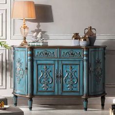 an ornate blue cabinet with gold accents in a living room