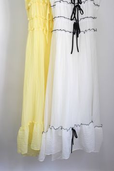 This Alora dress is sure to brighten up any day! The dress features an adjustable shoulder strap, ruffle detail and bow trim, contrast trim color on white color, and a flowy skirt, invisible zipper at back center, Lined. 100% Polyester White A-line Sundress With Tie Straps, White Ruffled Skirt Dress For Daywear, White Dress With Tie And Ruffled Straps, White A-line Dress With Tie Straps, White Sundress With Ruffled Straps, White Ruffle Hem Maxi Dress For Daywear, White Flowy Ruffled Dress, White Maxi Dress With Ruffle Hem For Daywear, White Ruffled Maxi Length Dress