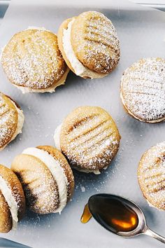 powdered sugar covered pastries on a tray with a spoon