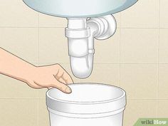 a person is filling a bucket with water from the faucet to the sink